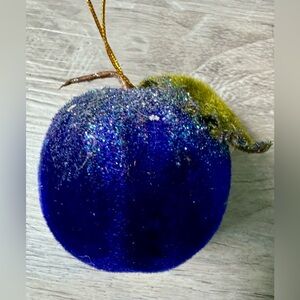 Christmas tree ornament. A plum-shaped ornament covered in glitter. The ornament